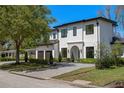 Beautiful two-story home showcasing modern architecture, a well-maintained lawn, and a spacious driveway at 1833 Loch Berry Rd, Winter Park, FL 32789