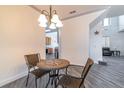 Dining area with a table with seating for two and grey wood-look floors at 1905 Snapper Dr, Kissimmee, FL 34759
