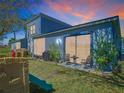 Outdoor patio area with seating, a grill, and a play area surrounded by lush green grass at 20604 Maxim Pkwy, Orlando, FL 32833