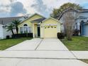 Beautiful single-story home boasting well-maintained landscaping, a driveway, and cheerful yellow siding at 3361 Hamlet Loop, Winter Park, FL 32792
