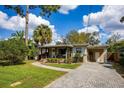Attractive single-story home with a brick walkway, cozy porch, and well-maintained landscaping at 3519 Backspin Ln, Orlando, FL 32804