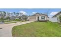 Inviting curb appeal with a well-maintained lawn and a view of the neighborhood at 4009 Swan Goose Ct, Okahumpka, FL 34762