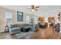 Open-concept living room featuring hardwood floors and a comfortable seating area at 4009 Swan Goose Ct, Okahumpka, FL 34762