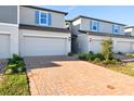 Charming townhome featuring a brick driveway, one-car garage and neat landscaping at 4332 Ranch House Rd, St Cloud, FL 34772