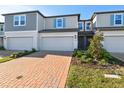 Charming townhome featuring a brick driveway, one-car garage and neat landscaping at 4332 Ranch House Rd, St Cloud, FL 34772