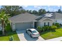 Well maintained home with neat landscaping, two car garage and a car parked in the driveway at 4475 Casablanca Ave, Kissimmee, FL 34746