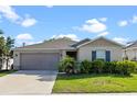 Charming single-Gathering home featuring a well-maintained lawn and an attached two-car garage at 4475 Casablanca Ave, Kissimmee, FL 34746