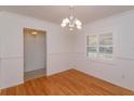 Bright dining room featuring wood floors, wainscoting, crown molding and large window at 519 Cornwall Rd, Winter Park, FL 32792