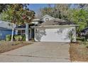 Well-kept home exterior with a spacious two-car garage and mature landscaping at 604 Coral Trace Blvd, Edgewater, FL 32132
