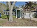 Inviting home exterior featuring lush greenery and an arched entryway at 604 Coral Trace Blvd, Edgewater, FL 32132