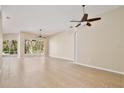 Spacious open-plan living room featuring tile floors and ceiling fans at 604 Coral Trace Blvd, Edgewater, FL 32132
