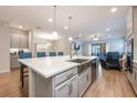 Bright kitchen with quartz countertops, stainless steel sink, and open layout to the living area at 706 Hyperion Dr, Debary, FL 32713