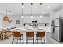 Bright kitchen boasts a quartz island with stylish seating and stainless appliances at 730 Longboat Dr, Davenport, FL 33896