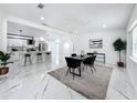 Modern dining room featuring an open layout with updated table, chairs, and view of the kitchen at 758 Osceola Dr, Sanford, FL 32773