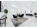 Bright dining room featuring a modern table set, stylish rug, and open-concept design leading to living area at 758 Osceola Dr, Sanford, FL 32773