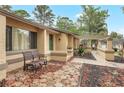 Charming home entrance with unique walkway, inviting bench seating, and manicured landscaping at 811 Gatehouse Dr, Winter Springs, FL 32708