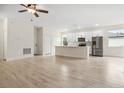 Spacious living room with a kitchen area that features modern stainless steel appliances at 833 S Hancock Dr, Deltona, FL 32725