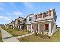 Street view of houses with red shutters and landscaping featuring well-maintained lawns at 11356 Sunsail Ave, Orlando, FL 32832