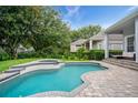 Inviting backyard pool and spa area, perfect for relaxation and entertaining with a fenced yard at 11537 Claymont Cir, Windermere, FL 34786