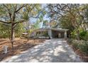 Welcoming single-story home with covered parking area and natural surroundings at 144 E Plantation Blvd, Lake Mary, FL 32746