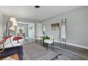 Bright living room featuring stylish decor, wood-look floors, and an open layout into the dining area at 1612 Eastbrook Blvd, Winter Park, FL 32792