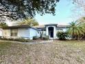 Well-maintained single-story home featuring a blue facade and a well-maintained, verdant front yard at 2024 Flaming Arrow Ct, Fern Park, FL 32730