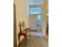 Inviting foyer featuring tile flooring, a high ceiling, and a decorative table, creating a welcoming entrance at 2024 Flaming Arrow Ct, Fern Park, FL 32730