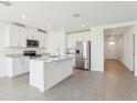 Bright kitchen boasts an island, stainless steel appliances, and white cabinets at 2094 Rosewood Dr, Bartow, FL 33830