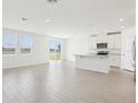 Open-concept living space with a modern kitchen, tile floors, and natural light at 2094 Rosewood Dr, Bartow, FL 33830