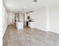 Spacious living room features tile flooring, open floor plan, and modern kitchen at 2511 Linda Knoll Ln, Bartow, FL 33830