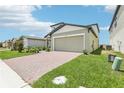 Beautiful home featuring a brick driveway, two-car garage, and well-maintained lawn at 3213 Viceroy Ct, Poinciana, FL 34759