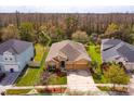 A full aerial view of the property, showcasing the green lawn, landscaping, and proximity to conservation at 3783 Moon Dancer Pl, St Cloud, FL 34772