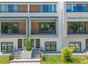 Close up of new construction townhomes featuring modern designs, front lawns and private entrances at 38 W Harding St # C, Orlando, FL 32806