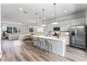 Modern kitchen with stainless steel appliances, a large island, and seamless open floor plan at 38 W Harding St # C, Orlando, FL 32806