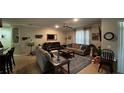 Bright living room featuring three sofas, neutral colors, ceiling fan, and nice decor at 4780 Cypress Forest Ln, St Cloud, FL 34772