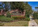 Clayton Crossing entrance sign with brick facade and manicured landscaping, creating an inviting welcome at 5252 Hidden Cypress Ln, Oviedo, FL 32765