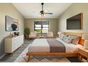 A beautifully staged main bedroom with a walk in closet and a nice view to the backyard at 8603 Primrose Dr, Kissimmee, FL 34747