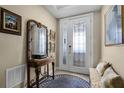 Inviting foyer featuring a decorative door, console table, rug, and a bench at 111 E Monument Ave # 705, Kissimmee, FL 34741