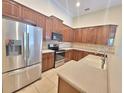Well-equipped kitchen with stainless steel appliances and granite countertops at 13413 Zori Ln, Windermere, FL 34786