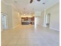 Open-concept living area showcasing tile flooring and seamless flow into the kitchen at 13413 Zori Ln, Windermere, FL 34786
