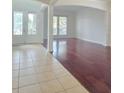 Open-concept space showcasing wood flooring, large windows, and tile flooring at the entrance at 13413 Zori Ln, Windermere, FL 34786
