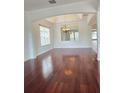 Open living room boasts hardwood floors, recessed lighting, and an elegant chandelier for a luxurious feel at 13413 Zori Ln, Windermere, FL 34786