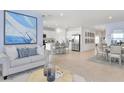 Open-concept living area featuring modern furnishings, dining area and a kitchen with an island at 146 Jones Fish Camp Rd, Edgewater, FL 32141