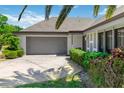 Inviting single-story home featuring a two-car garage, manicured landscaping, and a cozy front entrance at 1489 Magellan Cir # 603, Orlando, FL 32818