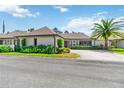 Beautiful single-story home showcasing lush landscaping, a palm tree, and an expansive driveway at 1489 Magellan Cir # 603, Orlando, FL 32818