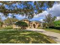 Gorgeous two-story home featuring a stone archway entry, three-car garage, luscious landscaping and circular driveway at 1704 Kersley Cir, Lake Mary, FL 32746