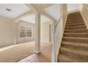 Inviting entryway featuring carpeted stairs, tiled floors, and arched openings that lead to other rooms at 1827 Lindzlu St, Winter Garden, FL 34787