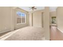 Spacious living room featuring neutral walls, carpeted floors, and a large window with natural light at 1827 Lindzlu St, Winter Garden, FL 34787