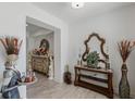 Entryway with wood-look floors, ornate console table, decorative mirror and console table decor at 1880 Bonser Rd, Minneola, FL 34715