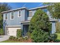 Charming two-story home with a 2-car garage, complemented by lush landscaping, providing privacy at 219 Meghan Cir, Deland, FL 32724